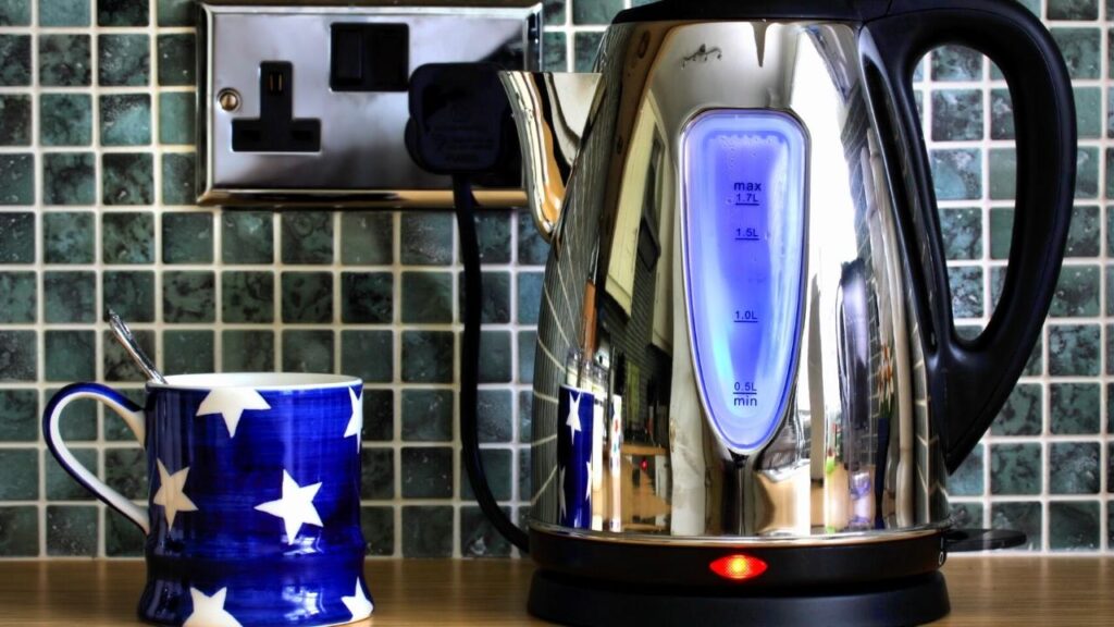kettle beside mug on kitchen worktop
