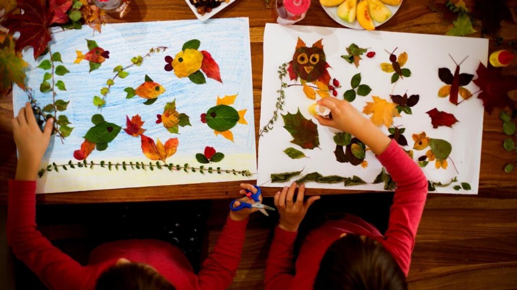 looking down on children making leaf pictures