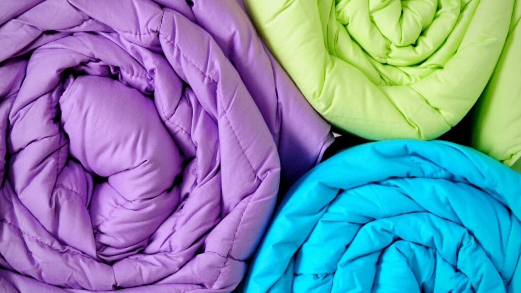 purple, blue and green duvets rolls
