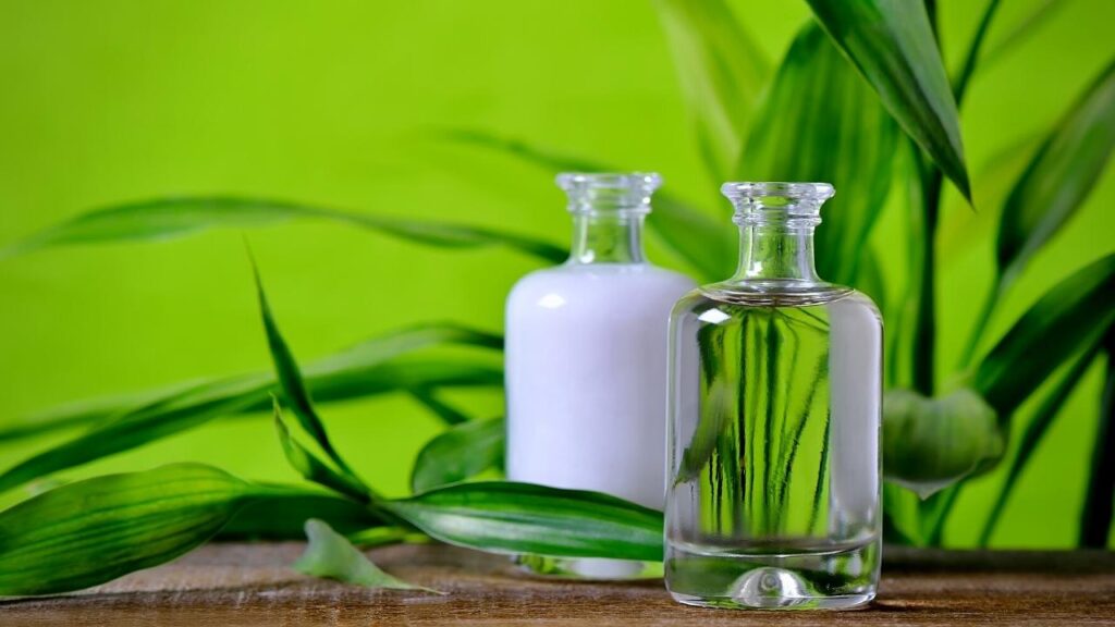 bottle of natural oils with green background