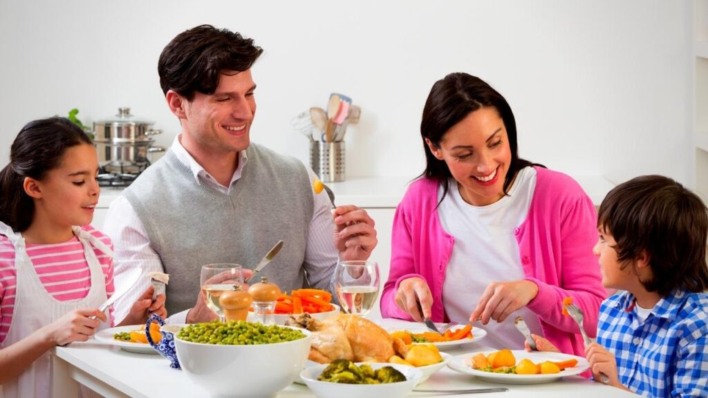 happy young family talking over dinner