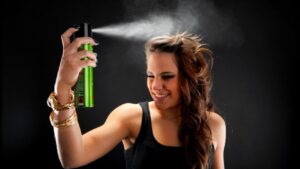 woman spraying her hair