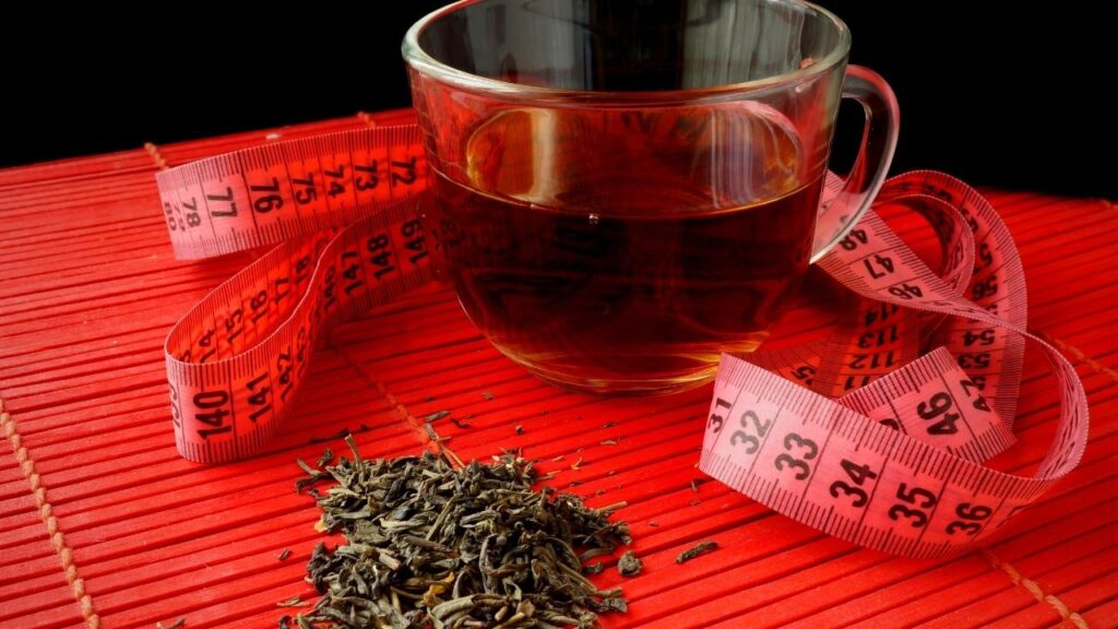 cup of green tea beside tape measure