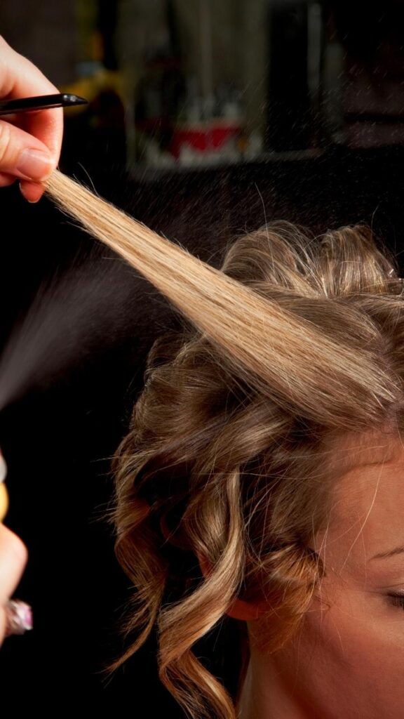 close up of hair strand being sprayed
