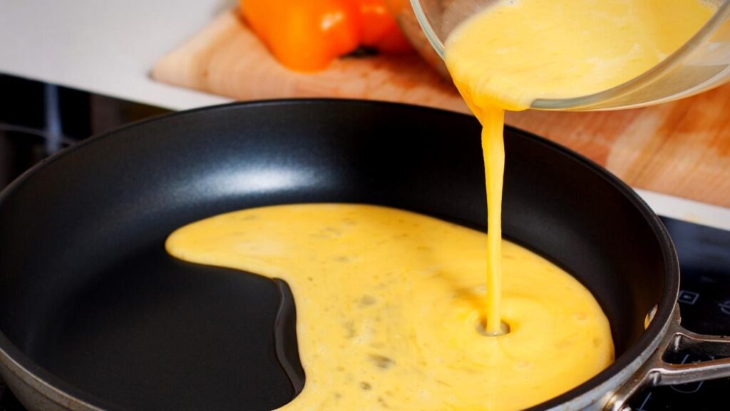 pouring egg mixture into pan