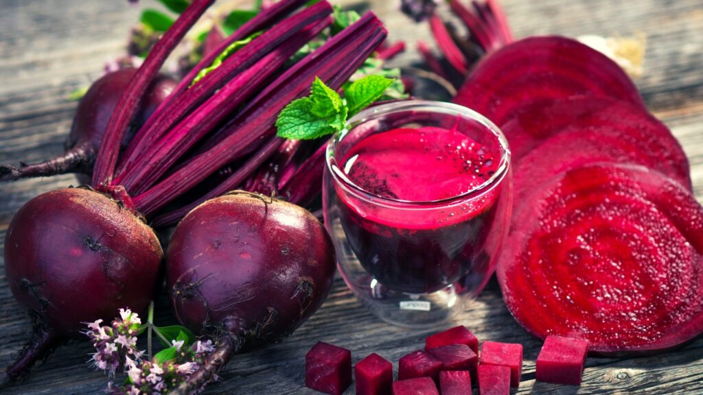 glass of beetroot juice beside beetroot