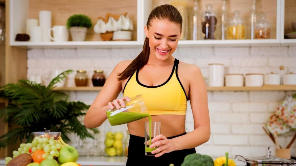 young woman making green juice